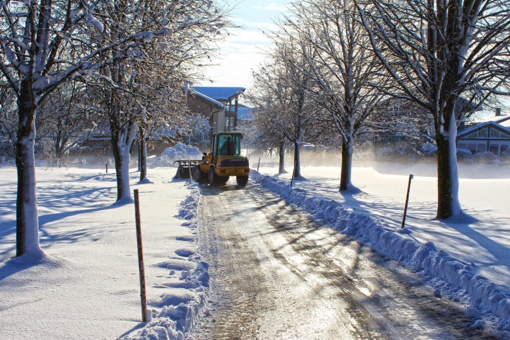 a snow plow clears snow from a residential road. what are the snow removal bylaws in waterloo?